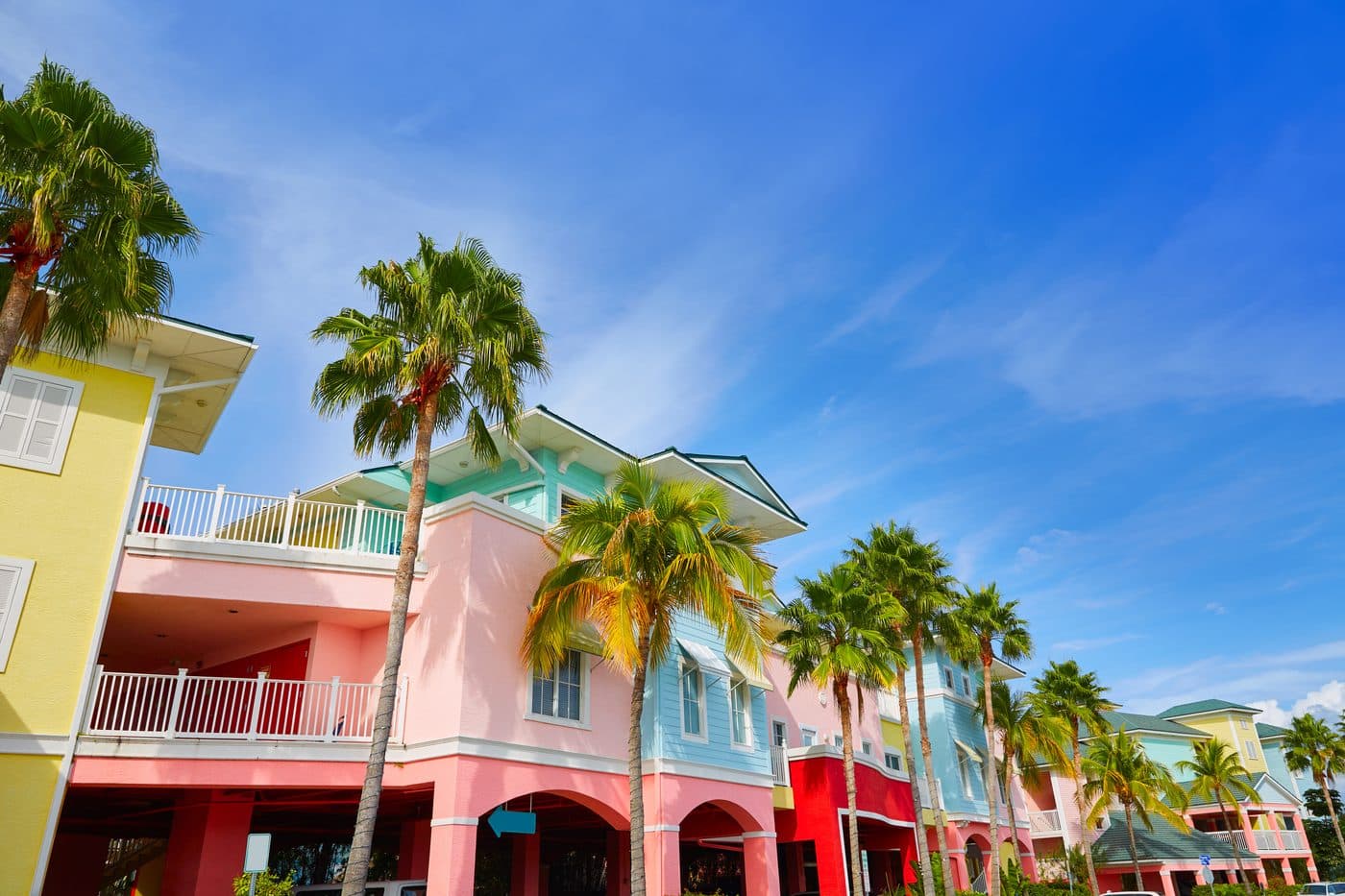 Colorful vacation rental homes lined with palm trees