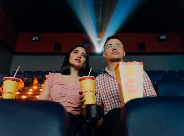 Couple sharing popcorn at the movies