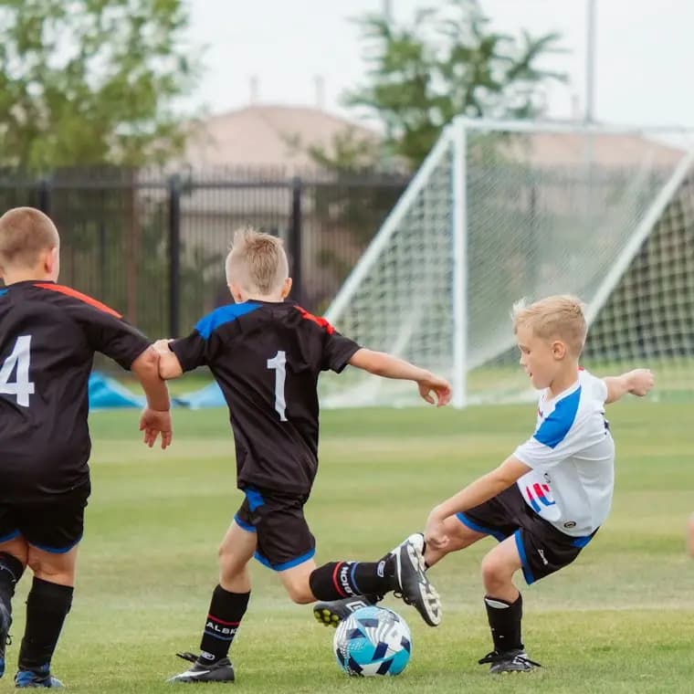 Kids playing in a youth soccer game